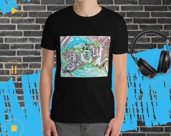 May include: Black t-shirt with a colorful graphic print of graffiti art. The art features a blue, pink, and green color scheme with white outlines. The art is centered on the shirt and is surrounded by a white border.