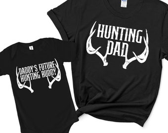 May include: Black t-shirt with white text that says "Hunting Dad" and white antlers. A black baby onesie with white text that says "Daddy's Future Hunting Buddy" and white antlers.