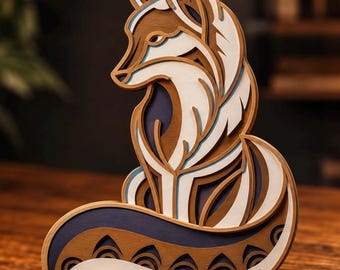 May include: A multi-layered wooden fox sculpture featuring intricate cutouts. The design incorporates shades of brown, white, and dark blue, creating a dimensional effect. The fox is depicted in a seated position with its tail curled around its body.