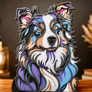 Puede incluir: Una pieza de arte mural de madera multicapa que representa a un perro con un pelaje multicolor en tonos morado, azul, negro, blanco y bronceado. El diseño en capas crea un efecto tridimensional, mostrando los rasgos faciales detallados del perro.