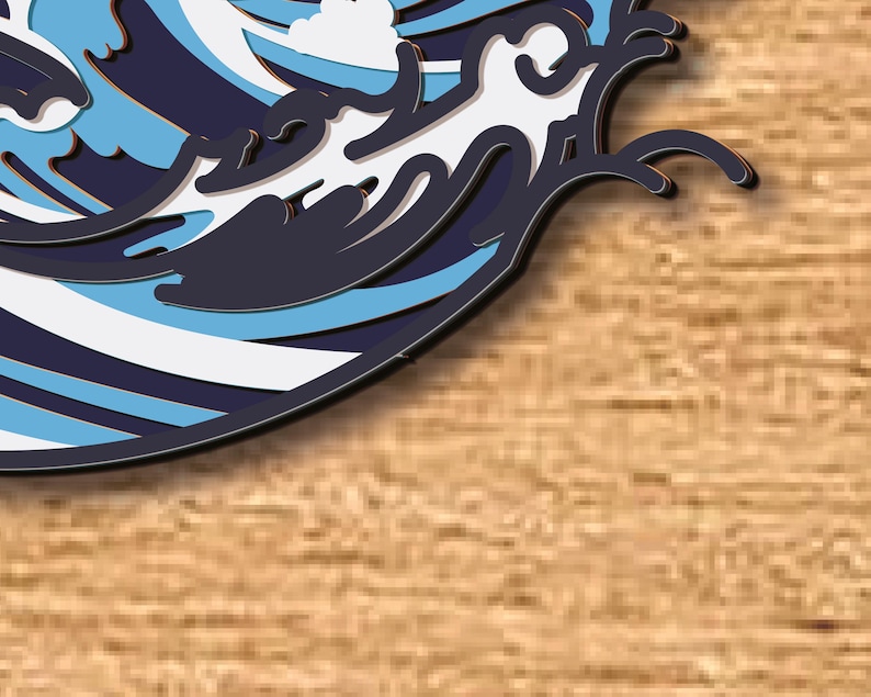 May include: A blue and white paper cut-out of a wave crashing on a wooden surface.