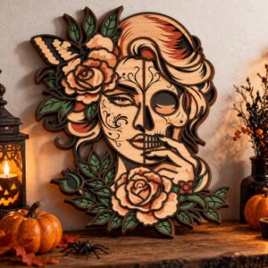 May include: A multi-layered wooden wall art piece featuring a woman with half her face as a skull, adorned with roses and leaves in shades of peach, green, and black. The design includes intricate floral details and a butterfly accent.