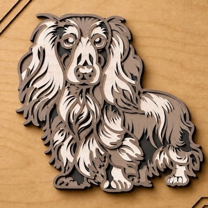 May include: A multi-layered wooden wall art piece depicting a long-haired dog. The design features stacked laser-cut wood panels in shades of light beige, medium brown, and dark charcoal, creating a dimensional silhouette of a canine with flowing fur.