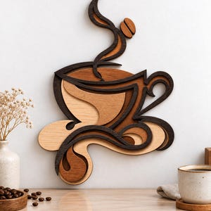 May include: A layered wooden wall art piece depicting a coffee cup with swirling steam and a coffee bean. The design features contrasting shades of dark, medium, and light brown wood, creating a dimensional effect with curved, fluid lines.