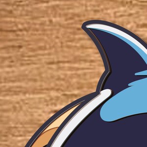 May include: A blue and white cartoon orca whale with a black fin. The orca is facing right and has a white belly and a black back.