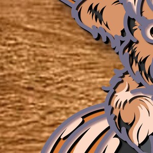 May include: A layered paper artwork depicting a dog's face, using shades of brown, tan, and grey. The art is set against a textured, wood-effect background, highlighting the dog's eye and fur details.