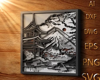 May include: A square multi-layered laser-cut wall art piece featuring a pagoda, a mountain, and a sun in shades of black, grey, and white. The text AI, DXF, DWG, EPS, PNG, and SVG is visible on the right side of the framed artwork.