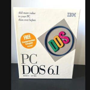 May include: A white IBM PC DOS 6.1 software box featuring the text Add more value to your PC than ever before, a circular logo with the word DOS in green, yellow, and pink, and an orange circle stating FREE Compression Coupon inside.