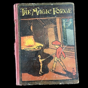 May include: Vintage book cover titled "The Magic Forge." The cover illustration depicts a blacksmith's forge with a fiery furnace, a figure with a rod, and a boy in a red shirt and cap. The book has a pink spine.