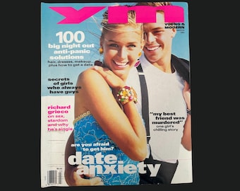 May include: A magazine cover with the title "YM" in pink and blue. The cover features a smiling woman and man. Text includes "100 big night out anti-panic solutions" and "date anxiety."