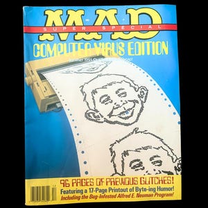 Op de afbeelding: Een vintage MAD Super Special magazine, "Computer Virus Edition." De cover heeft een blauwe achtergrond met het MAD-logo en een afdruk van het gezicht van Alfred E. Neuman. Het tijdschrift bevat 96 pagina's met glitches en een 17 pagina's lange afdruk met byte-humor.