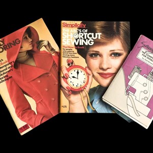 May include: Three vintage sewing books against a black backdrop. Titles include "Simply Tailoring", "The ABC's of Shortcut Sewing", and "Sewing With Sergers". The covers display a woman in a red coat, a woman with a stopwatch, and a sewing machine.