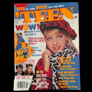 May include: A vintage magazine cover featuring the word "TEEN" in large orange letters. The cover model is a young woman wearing a red and black hat and a black and white scarf. The magazine includes articles on beauty, relationships, and fashion.