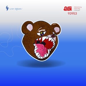 May include: Brown teddy bear with a large, open mouth showing sharp teeth and a pink tongue. The bear's eyes are wide open and have a surprised expression. The bear is embroidered on a white background.
