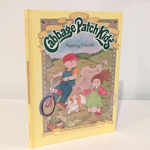 May include: A hardcover "Cabbage Patch Kids" storybook titled "Making Friends." The cover features illustrations of children, a dog, and a bicycle. The book is yellow with green and red accents. The book is a Parker Brothers Story Book.