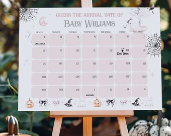 May include: A baby shower game sign on a wooden easel. The sign is light pink with the text "Guess the Arrival Date of Baby Williams." The sign has a calendar layout with decorative pumpkins, bows, and witch hats. Pumpkins are in the foreground.