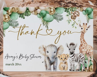 May include: Thank you card with a gold heart and the text "Thank you" in gold script. The card features a green and gold balloon garland with a giraffe, zebra, elephant, and lion. The text "Avery's Baby Shower" and "March 20xx" is printed below the animals.