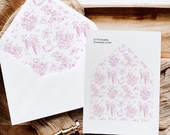 May include: A white envelope with a pink floral pattern printed on the inside. The envelope is lying on a wooden surface with a gold wax seal and a piece of fabric. The text on the card reads "A7 Printable Envelope Liner".