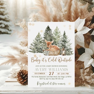 May include: A baby shower invitation with a winter theme. The design features a watercolor illustration of a fawn in a basket, pine trees, and the text "Baby it's Cold Outside". The invitation includes details for Avery Williams' baby shower.