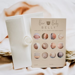 May include: A beige card with the text "Beer or Baby Belly" and a bear icon. The card has a grid of 12 circles with photos of pregnant bellies. The text "How well do you know your baby bumps?" is printed below the title. There are blank lines for "Name" and "Score" at the bottom of the card.