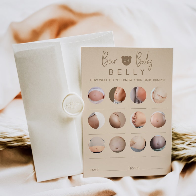May include: A beige card with the text "Beer or Baby Belly" and a bear icon. The card has a grid of 12 circles with photos of pregnant bellies. The text "How well do you know your baby bumps?" is printed below the title. There are blank lines for "Name" and "Score" at the bottom of the card.