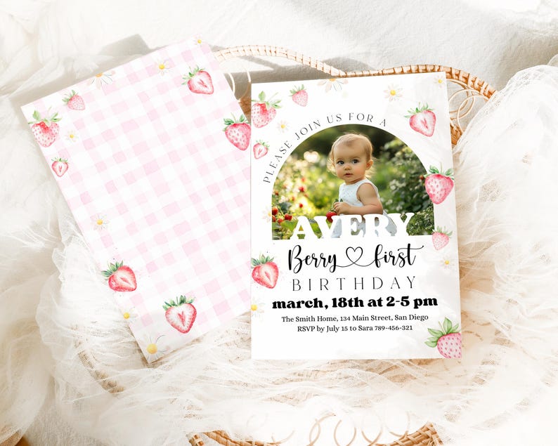 May include: Avery Berry first birthday invitation with a photo of a baby. The invitation features a white background with a strawberry and daisy design. The text includes the date, time, and location of the party.
