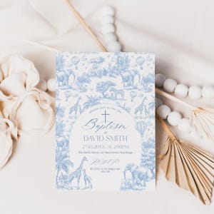 May include: A baptism invitation with a blue and white safari animal toile pattern. The invitation includes the text "Baptism of David Smith" and RSVP information. The design features elephants, giraffes, and hot air balloons.