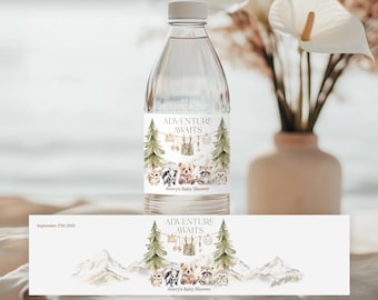 May include: A clear water bottle with a label that reads "Adventure Awaits" with illustrations of trees, mountains, and woodland animals. The label also includes the text "Avery's Baby Shower". A matching label is below the bottle.