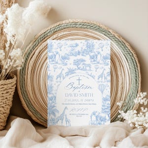 May include: A baptism invitation card with a blue and white safari animal design. The card includes the text "please join us for the Baptism of DAVID SMITH" and RSVP information. The card is set against a woven background.