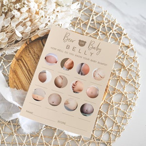 May include: A beige card with the text "Beer or Baby Belly" and a brown bear icon. The card has a game with 12 images of pregnant bellies and a space for a name and score.