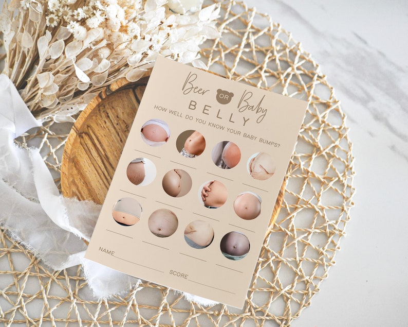 May include: A beige card with the text "Beer or Baby Belly" and a brown bear icon. The card has a game with 12 images of pregnant bellies and a space for a name and score.
