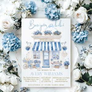 May include: A baby shower invitation with a watercolor illustration of a shop with blue and white striped awning, surrounded by blue and white flowers. The invitation reads "Bonjour bébé" and includes event details for Avery Williams.