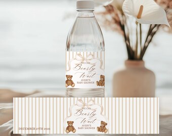 May include: A clear water bottle with a custom label for a baby shower. The label features the text "We Can Bearly Wait" with teddy bear illustrations. The date "December 27th 2025" is also printed on the label.