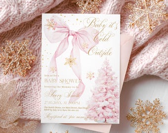 May include: A baby shower invitation with a pink bow and a pink Christmas tree design. The invitation reads "Baby it's Cold Outside" in gold script. Gold snowflake decorations surround the invitation on a pink knitted background.