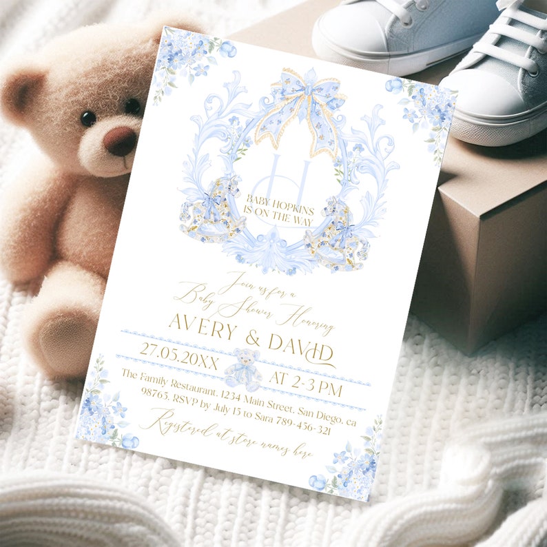 Op de afbeelding: Een blauwe en gouden babyborrel uitnodiging met een bloemenontwerp. De uitnodiging zegt "Baby Hopkins is on the way" en "Join us for a Baby Shower Honoring Avery & David". De datum en tijd van de borrel zijn vermeld als "27.05.20XX om 14:00-15:00 uur". De locatie is vermeld als "The Family Restaurant, 1234 Main Street, San Diego, CA 98765". De RSVP-informatie is vermeld als "RSVP voor 15 juli aan Sara 789-456-321".