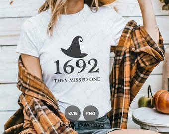 May include: White t-shirt with a black witch hat graphic and the text "1692 They Missed One".