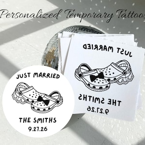 May include: Personalized temporary tattoos featuring a black and white graphic of two clogs, one with a bow tie and one with lace, with the text JUST MARRIED, THE SMITHS, and 9.27.26 printed on circular and square white paper sheets.
