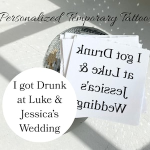May include: A stack of white square temporary tattoos featuring the black text I got Drunk at Luke & Jessica's Wedding. The text is printed in reverse on the paper sheets, with a circular overlay showing the text in a readable orientation.