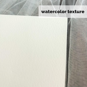 May include: Close-up of a white watercolor paper with a textured surface. The paper is positioned next to a sheer, white fabric. The words "watercolor texture" are printed in black.
