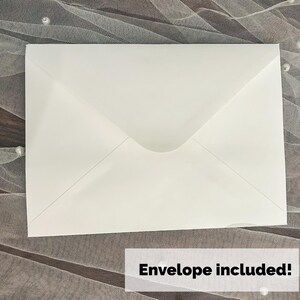May include: A white envelope with a pointed flap, lying on a textured surface. The text "Envelope included!" is displayed in a white rectangle at the bottom of the image. The envelope is a standard size.