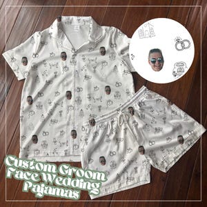 May include: White satin pajama set with a custom face pattern and wedding-themed doodles. The set includes a button-down shirt and shorts. The text "Custom Groom Face Wedding Pajamas" is displayed at the bottom of the image.