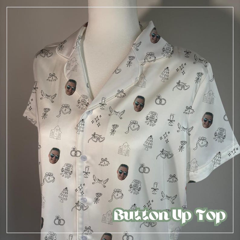 May include: White button-up top with a pattern of black line art wedding-themed illustrations and faces. The illustrations include wedding cakes, bells, rings, and doves. The text "Button Up Top" is at the bottom of the image.