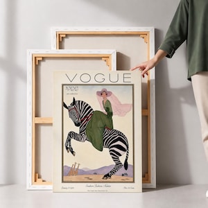 Digitally restored 1926 Vogue magazine cover titled Southern Fashions Number, featuring a stylish woman in a flowing green dress and pink hat riding a zebra in a desert landscape with giraffes and mountains. Vintage Art Deco fashion illustration digital download ideal for gallery walls, eclectic decor, and gifts for fashion history and vintage art lovers.