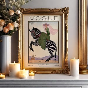 Digitally restored 1926 Vogue magazine cover titled Southern Fashions Number, featuring a stylish woman in a flowing green dress and pink hat riding a zebra in a desert landscape with giraffes and mountains. Vintage Art Deco fashion illustration digital download ideal for gallery walls, eclectic decor, and gifts for fashion history and vintage art lovers.