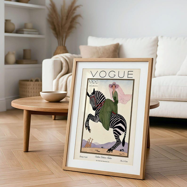 Digitally restored 1926 Vogue magazine cover titled Southern Fashions Number, featuring a stylish woman in a flowing green dress and pink hat riding a zebra in a desert landscape with giraffes and mountains. Vintage Art Deco fashion illustration digital download ideal for gallery walls, eclectic decor, and gifts for fashion history and vintage art lovers.