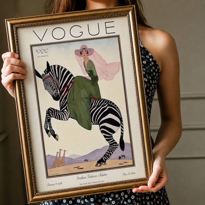 Digitally restored 1926 Vogue magazine cover titled Southern Fashions Number, featuring a stylish woman in a flowing green dress and pink hat riding a zebra in a desert landscape with giraffes and mountains. Vintage Art Deco fashion illustration digital download ideal for gallery walls, eclectic decor, and gifts for fashion history and vintage art lovers.