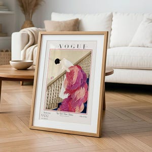 Digital Download Of A November 1 1924 Vogue Cover By George Wolfe Plank Showing An Art Deco Woman In A White Winter Gown Leaning Over A Staircase Toward A Pink Rose With Dramatic Pink Feathered Train. Printable Vintage Wall Decor For Cottagecore Farmhouse Glam Gallery Walls Fashion History Lovers And Gift Buyers.