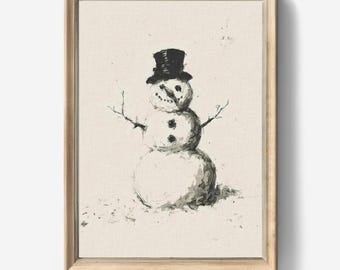 May include: A framed wall art print featuring a charcoal-style sketch of a snowman wearing a top hat. The snowman has twig arms, a carrot nose, and two buttons on its chest. The artwork is set against a textured, off-white canvas background.