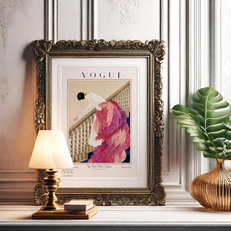 Digital Download Of A November 1 1924 Vogue Cover By George Wolfe Plank Showing An Art Deco Woman In A White Winter Gown Leaning Over A Staircase Toward A Pink Rose With Dramatic Pink Feathered Train. Printable Vintage Wall Decor For Cottagecore Farmhouse Glam Gallery Walls Fashion History Lovers And Gift Buyers.