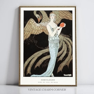 May include: A framed art print featuring a figure in a light blue gown standing before a large gold bird with spread wings against a black background. The figure holds a round orange object. Text at the bottom reads SORTILÈGES ROBE DU SOIR, DE BEER.